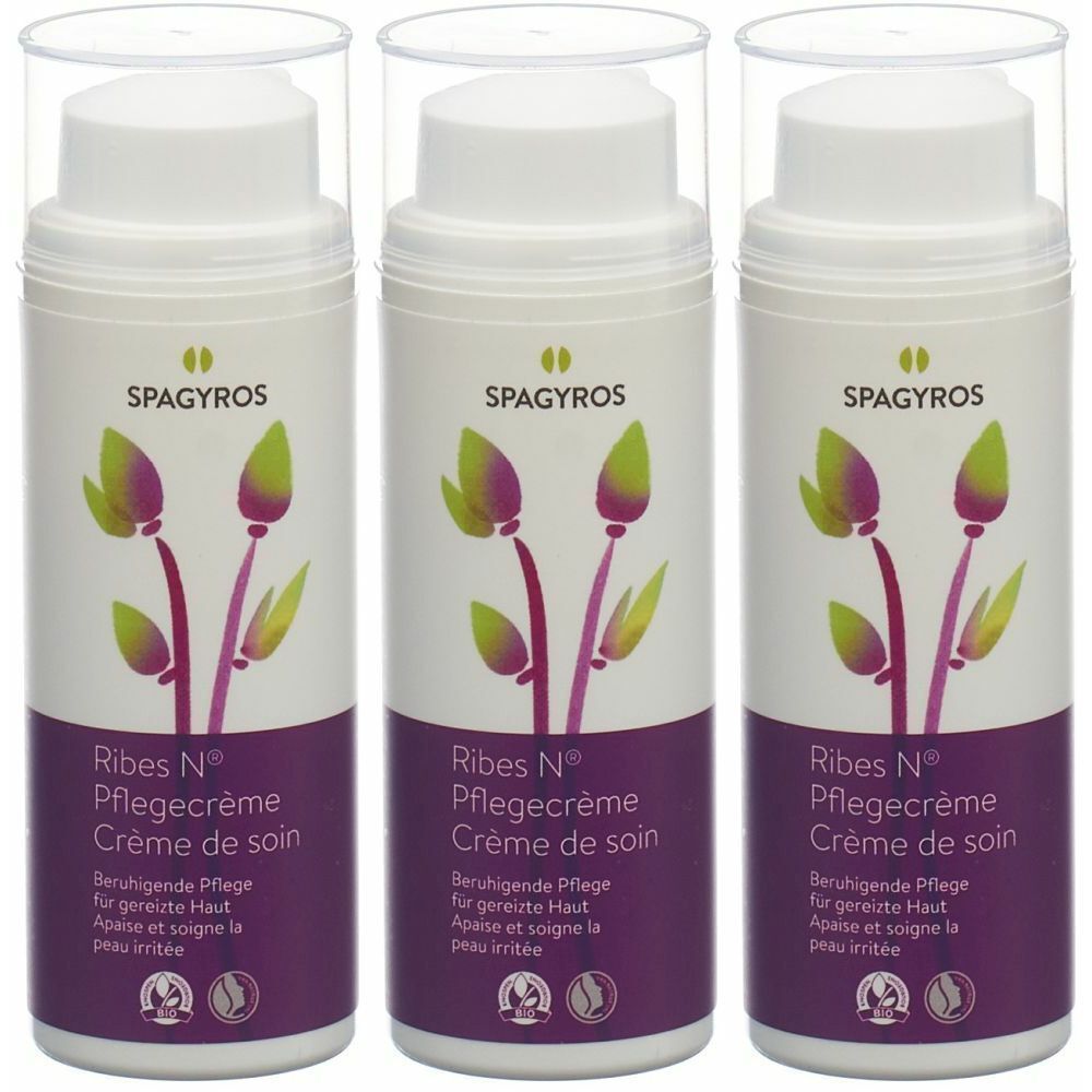 Drei weiße Spenderflaschen mit transparentem Deckel. Aufschrift: SPAGYROS, Ribes N Pflegecrème. Lila-grünes floral Muster.