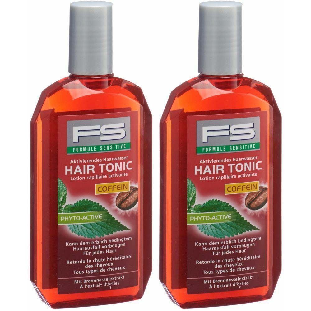 Zwei Flaschen Haarwasser mit roter Flüssigkeit. Aufschrift: FS HAIR TONIC COFFEIN. Mit Pflanzenabbildung und Text.