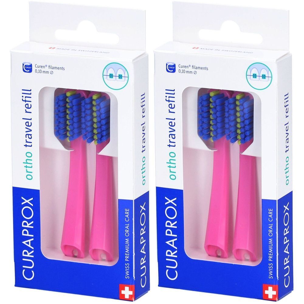 Zwei pinkfarbene Zahnbürsten-Aufsätze in Verpackung. Blaue Borsten, gelbe Akzente. Marke CURAPROX, ortho travel refill.