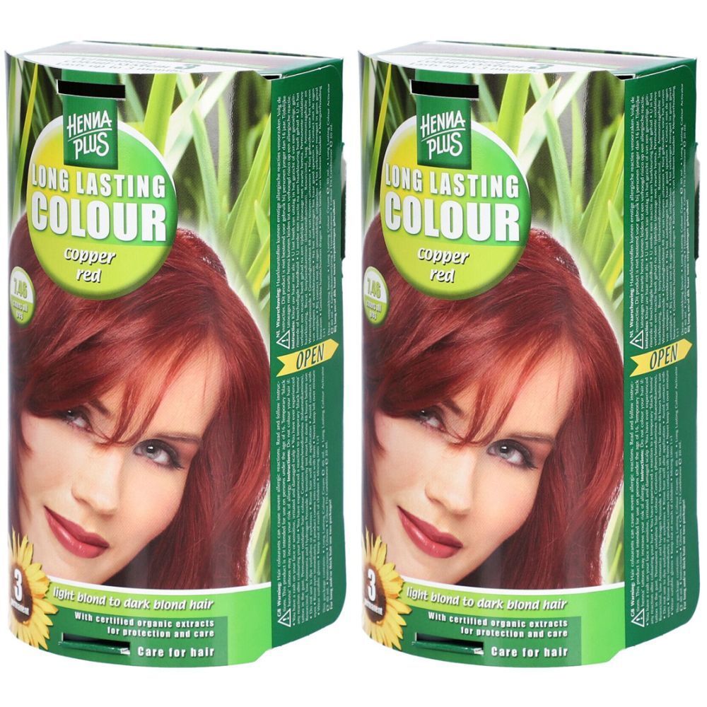 Zwei Packungen Haarfarbe. Aufschrift: HENNA PLUS LONG LASTING COLOUR, Kupferrot. Abbildung einer Frau mit rotem Haar. Grün-weiße Verpackung.