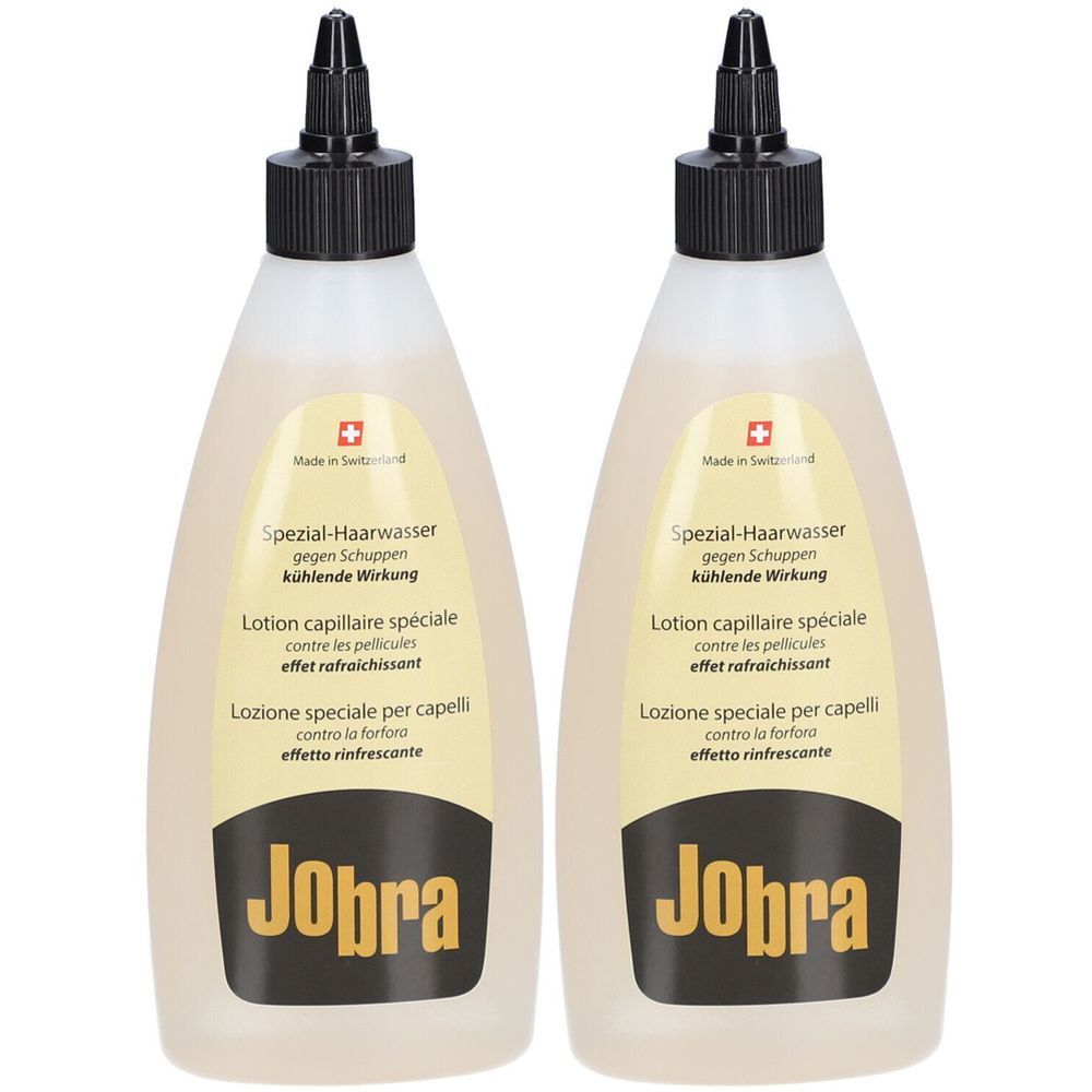 Zwei Flaschen Lotion mit schwarzem Verschluss. Aufschrift: Jobra, Spezial-Haarwasser gegen Schuppen, kühlende Wirkung.