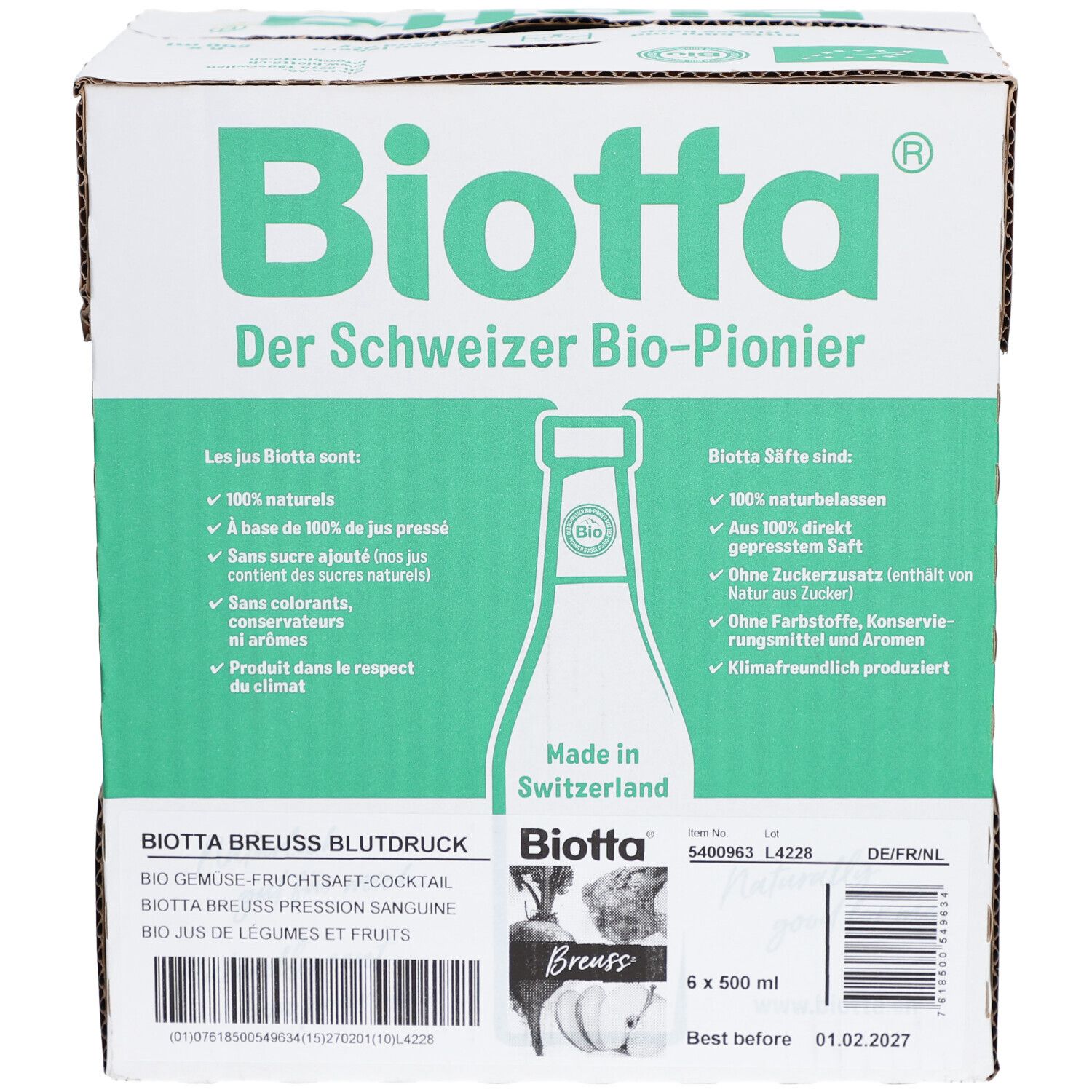 Carton Biotta. Contient 6 bouteilles de 500 ml. Inscriptions en allemand, français et néerlandais. Marque de certification bio.