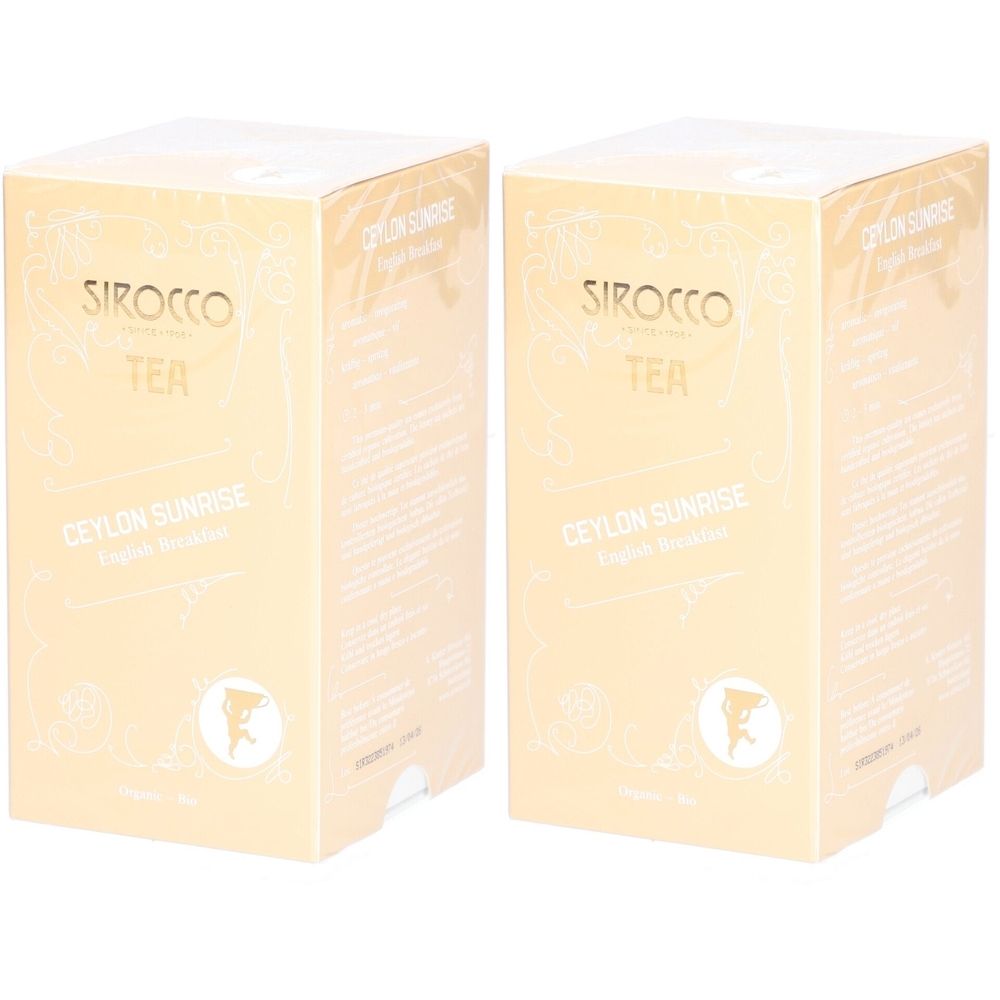 Zwei rechteckige Kartons. Aufschrift: Sirocco Tea, Ceylon Sunrise. Beige-goldene Verpackung.