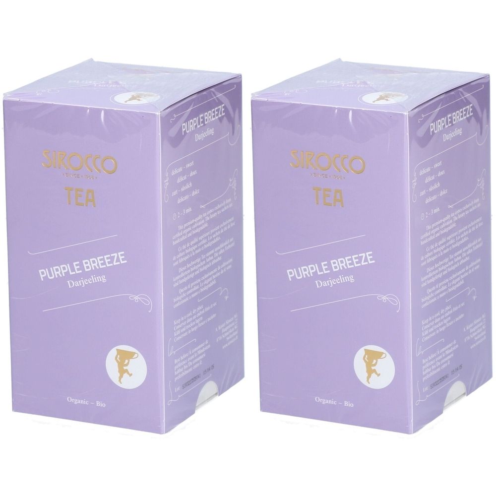 Zwei lilafarbene Kartons mit der Aufschrift "Sirocco Tea Purple Breeze Darjeeling". Aufdrucke in Gold und Weiß.