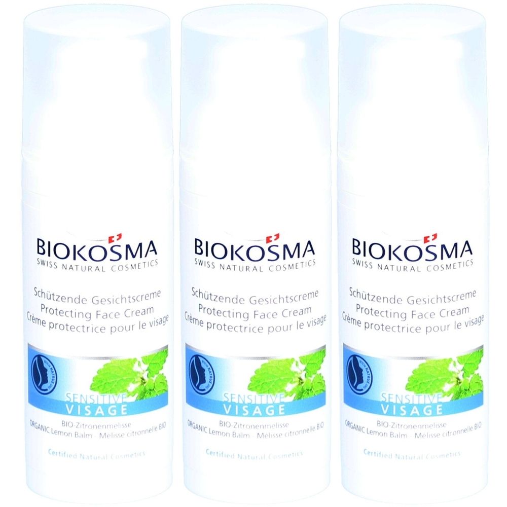 Trois flacons blancs avec étiquettes. Inscription: BIOKOSMA, crème protectrice pour le visage, Sensitive Visage. Illustration de menthe.
