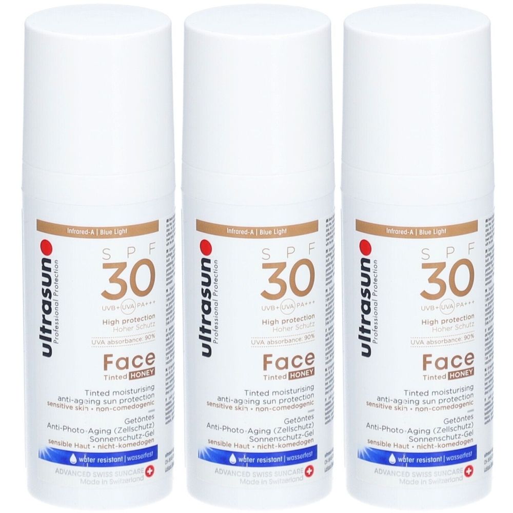Drei weiße Flaschen mit braunen Etiketten. Aufschrift: SPF 30, Face, HONEY. Marke: Ultrasun.