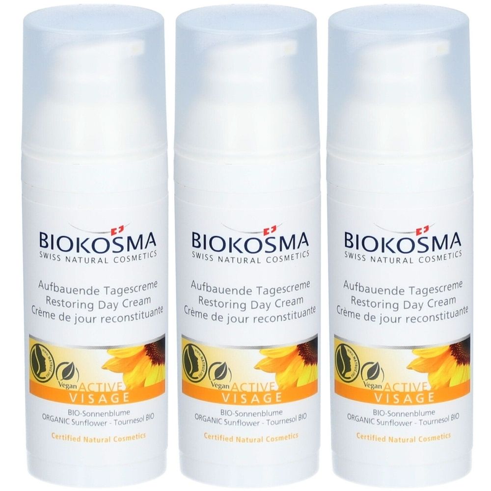 Trois crèmes blanches avec bouchons. Inscription: BIOKOSMA, Aufbauende Tagescreme, Restoring Day Cream, Active Visage. Logo tournesol.