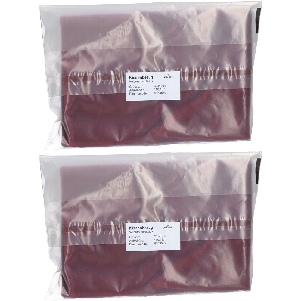 Zwei Kissenbezüge in Folienverpackung. Bordeauxfarben, rechteckig. Etikett mit Produktinformationen.