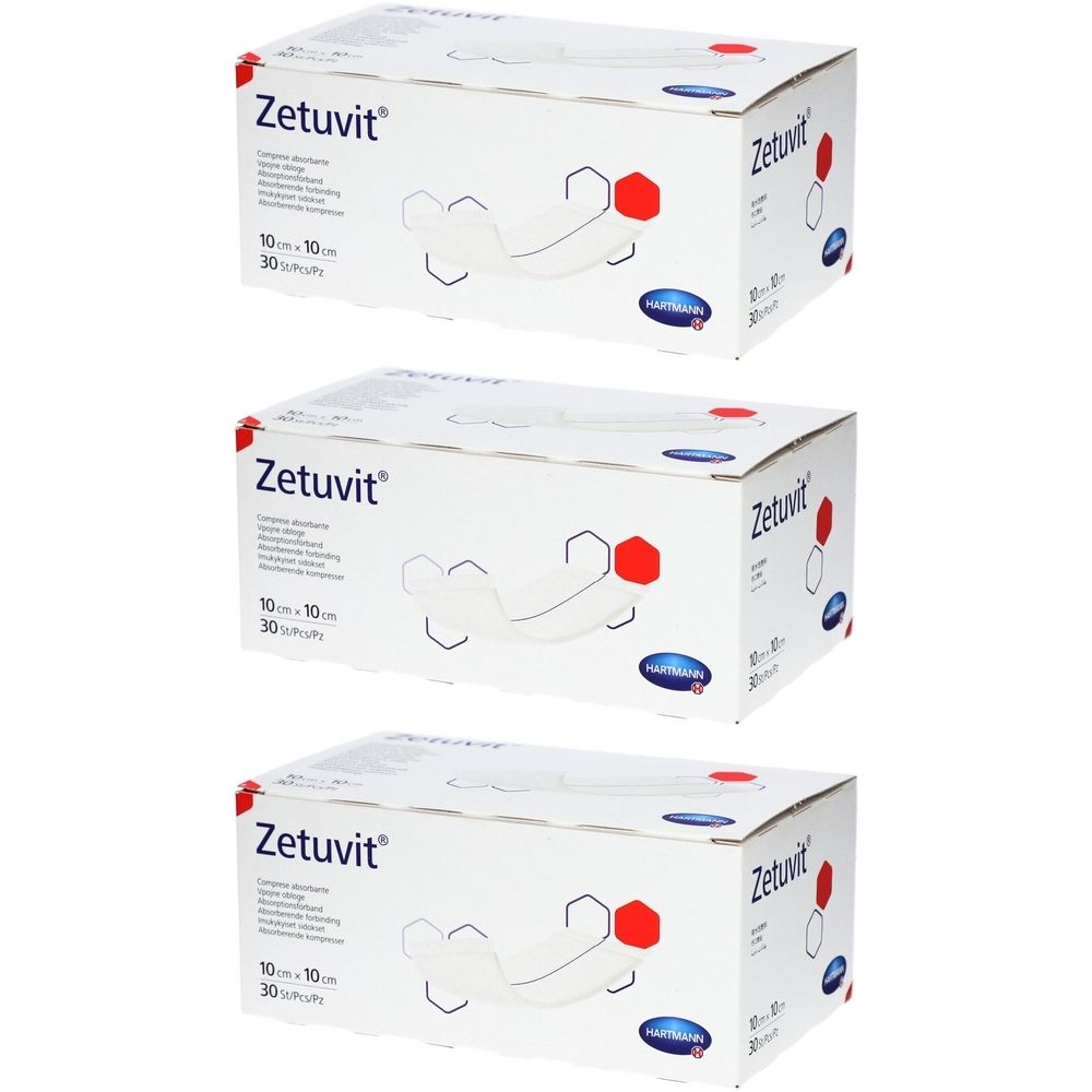 Drei Kartons Zetuvit Saugkompressen. Weiße Verpackung mit Produktabbildung und Schriftzug. Größe 10 x 10 cm.