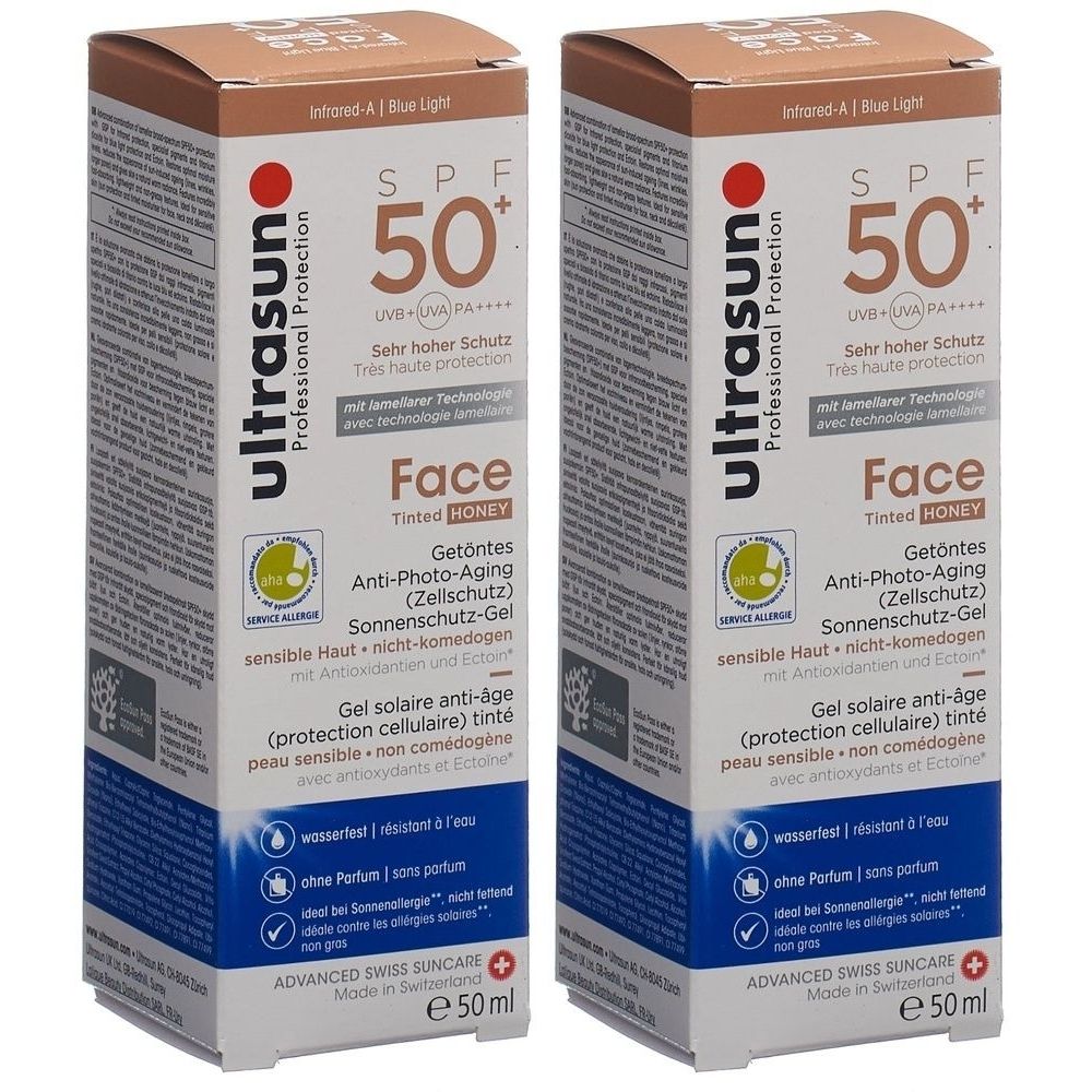 Deux boîtes de crème solaire. Inscription : ultrasun, SPF 50+, Face, anti-âge, teintée, 50 ml. Avec label de qualité.