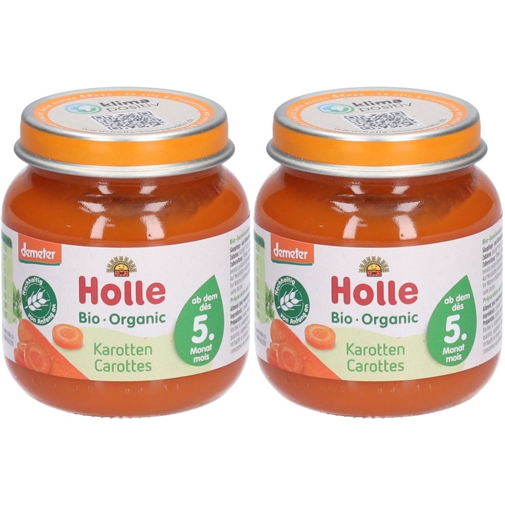 Deux pots de nourriture pour bébé Holle Bio-Organic Carottes. Pots avec contenu orange, couvercles et étiquettes. Label Demeter.