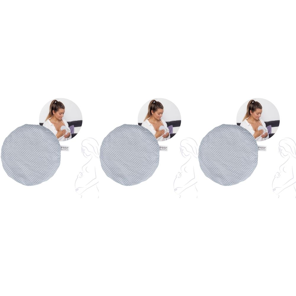 Rundes, hellgraues Kissen mit gepunktetem Muster. Im Hintergrund eine Frau, die stillt. Mehrere Kissen sind abgebildet.