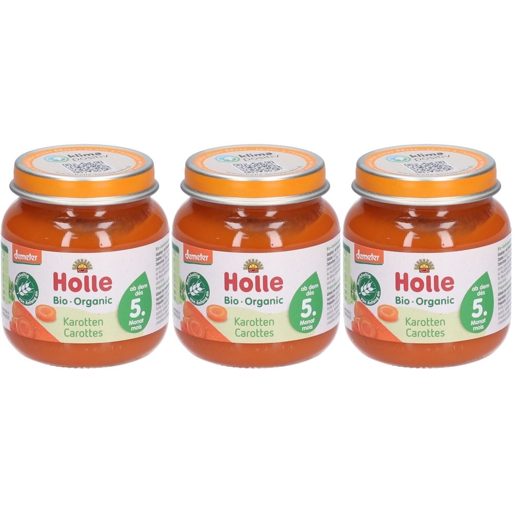 Trois pots de Holle Bio-Organic Carottes. Couvercles orange, étiquettes avec illustration de carottes et texte. Label Demeter.