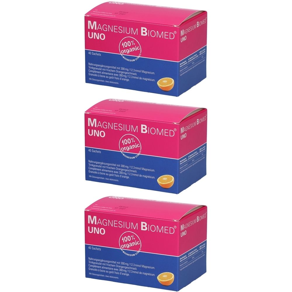 Drei Schachteln Magnésium Biomed UNO. Rosa-blaue Verpackung mit Produktnamen und "100% organic"-Logo. Abgebildet ist eine Orange.