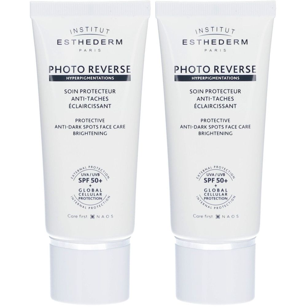 Zwei Tuben Institut Esthederm Photo Reverse SPF 50+. Weiße Tuben mit blauer und schwarzer Schrift. Text: Anti-Flecken, Aufhellung.