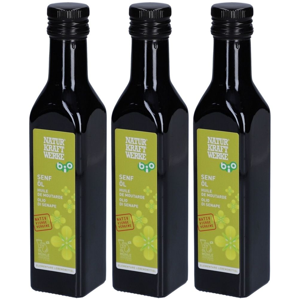 Trois bouteilles d'huile de moutarde bio. Bouteilles noires avec bouchons noirs et étiquettes avec informations et label bio.