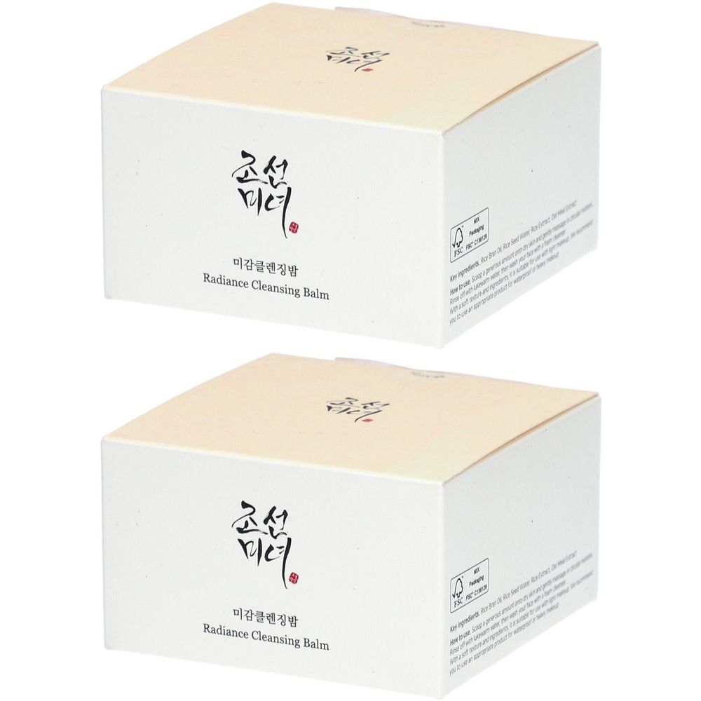 Zwei quadratische Kartons mit cremefarbenen Deckeln. Auf der Vorderseite befindet sich koreanische Schrift und der Schriftzug "Radiance Cleansing Balm".
