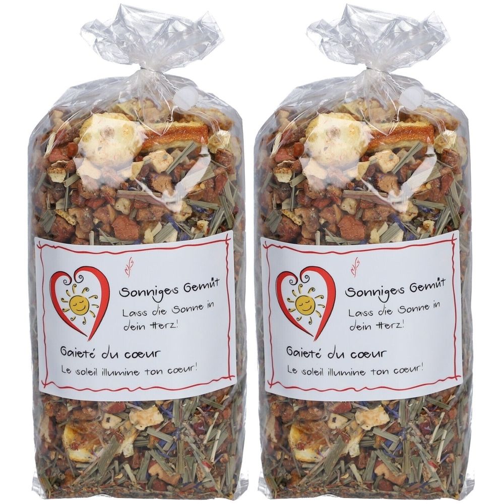 Deux sachets de tisane avec l'inscription 'Sonniges Gemüt'. Herbes et fruits visibles. Emballé dans un sachet transparent.