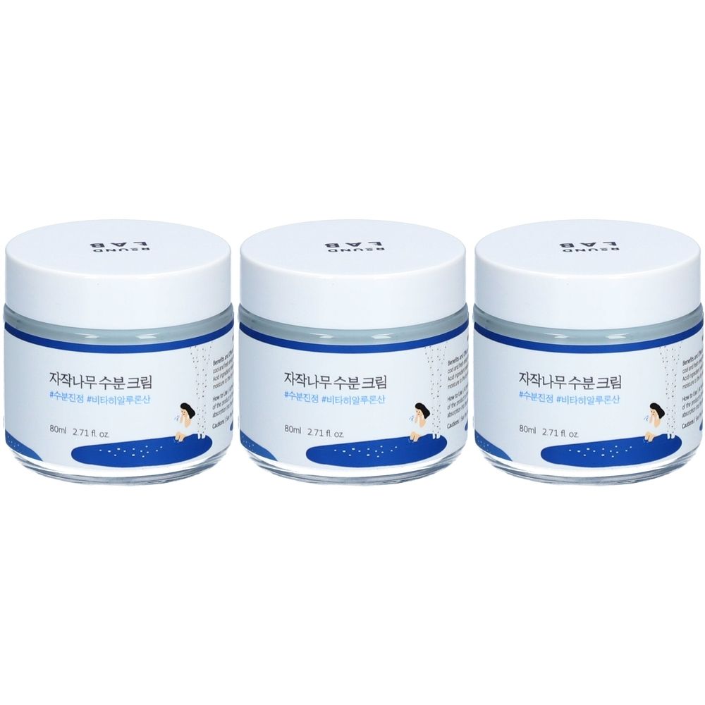 Drei weiße Tiegel mit blauem Rand und Deckel. Auf den Etiketten steht koreanischer Text und die Aufschrift "ROUND LAB".