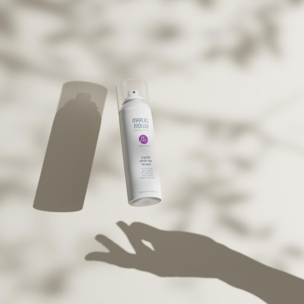 Weiße Sprühflasche mit transparentem Deckel, beschriftet mit 'MARLIES MÖLLER' und 'crystal shine hairspray'.