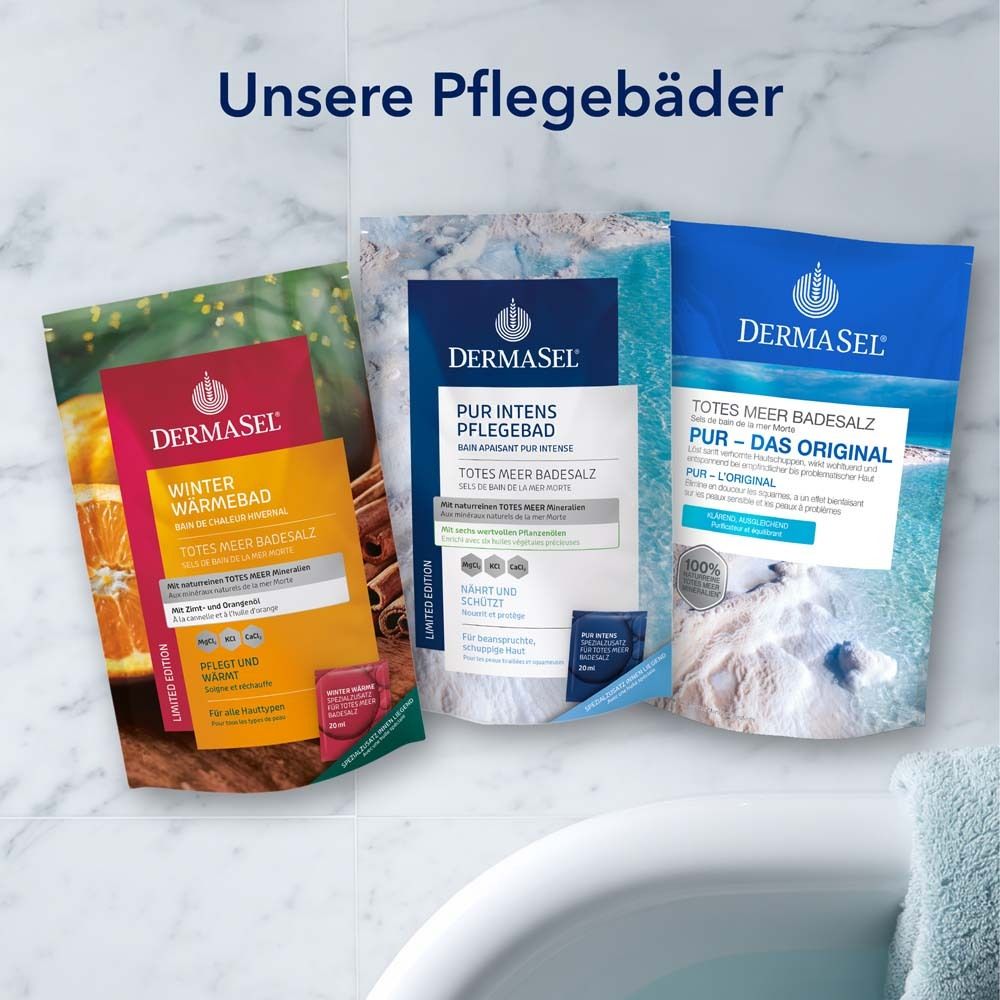 Drei DermaSel Badesalz-Verpackungen. Winter Wärme, Pur Intens, Pur Original. Auf Badewannenrand.