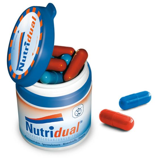 Behälter mit blauen und roten Kapseln. Der Deckel ist geöffnet und zeigt den Markennamen Nutridual.