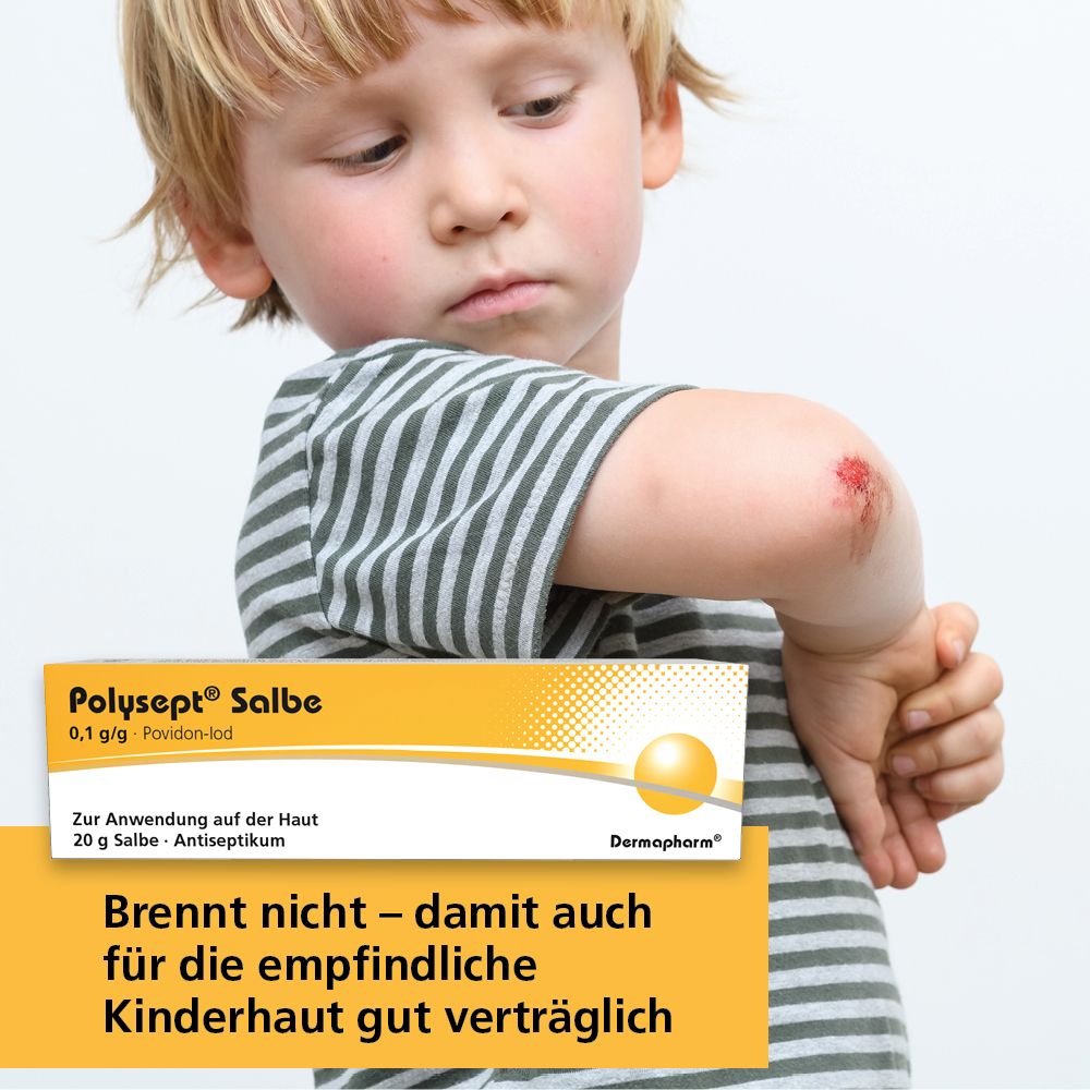 Kind mit Wunde am Ellenbogen. Polysept Salbe-Packung im Hintergrund. Nicht brennend, für Kinderhaut.