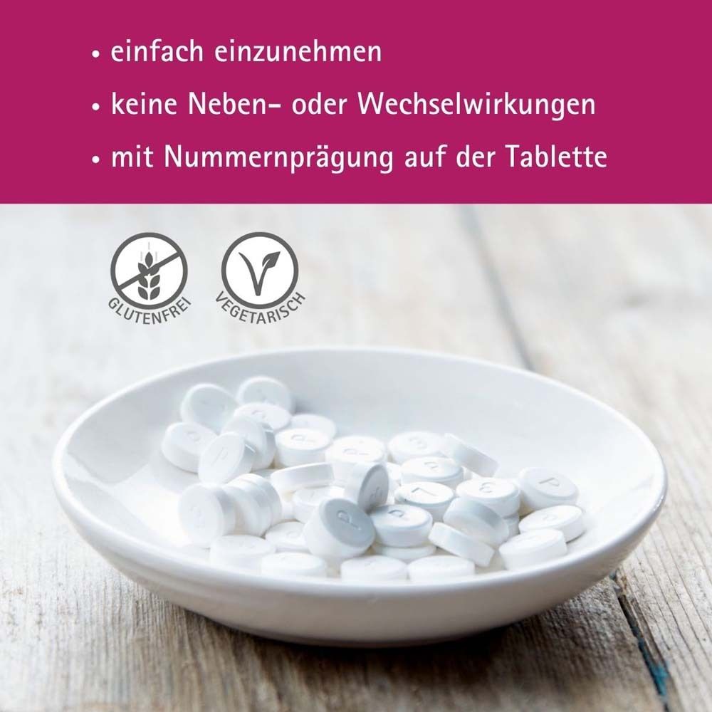 Weiße Tabletten in einer Schale. Text: glutenfrei, vegetarisch, mit Nummerprägung auf der Tablette.