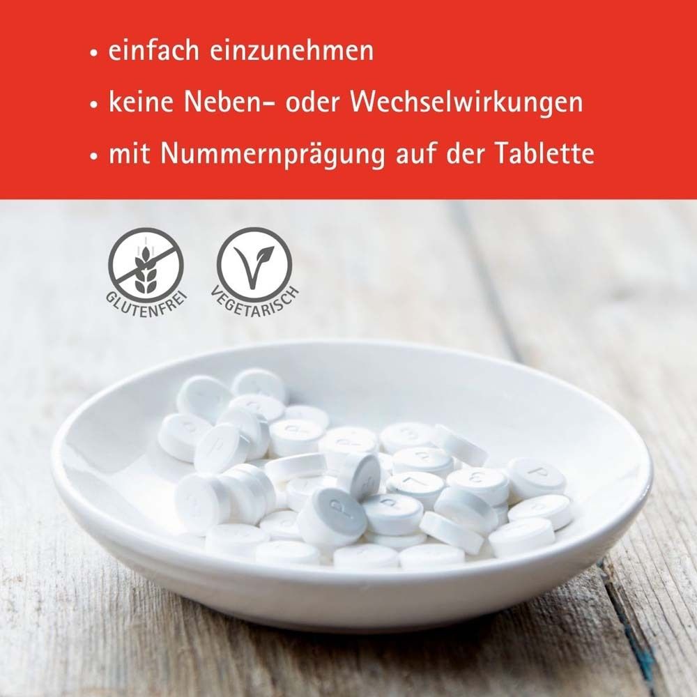 Weiße Tabletten in einer Schale. Text: glutenfrei, vegetarisch. Aufschrift auf Tabletten.