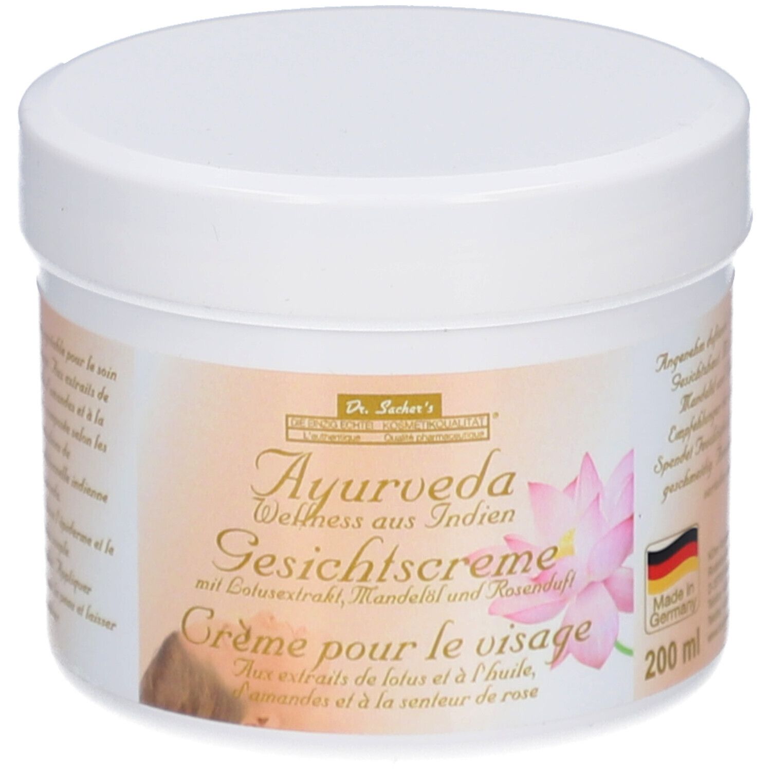 Weißer Tiegel mit Deckel. Etikett mit Text: Dr. Sacher's Ayurveda Gesichtscreme mit Lotusextrakt, Mandelöl und Rosenduft.