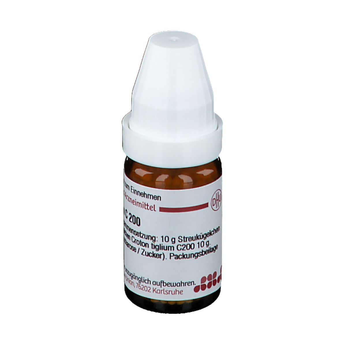 Braune Glasflasche mit weißem Deckel. Beschriftung: Croton tiglium C 200. Enthält Streukügelchen. Deutsche Homöopathie-Union.