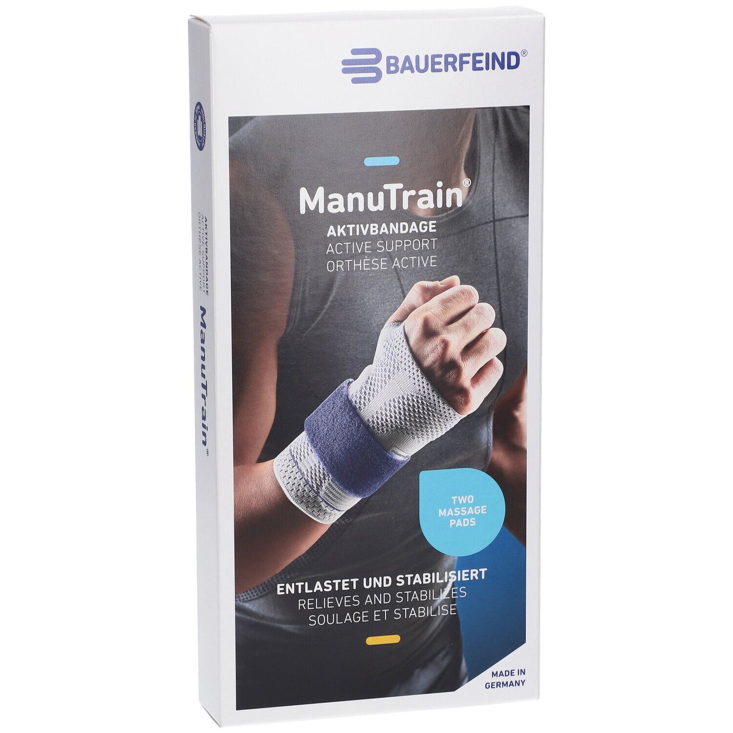 Verpackung mit Handgelenkbandage. Marke Bauerfeind. Aufdruck: ManuTrain, Aktivbandage, zwei Massagepads. Entlastet und stabilisiert. Made in Germany.