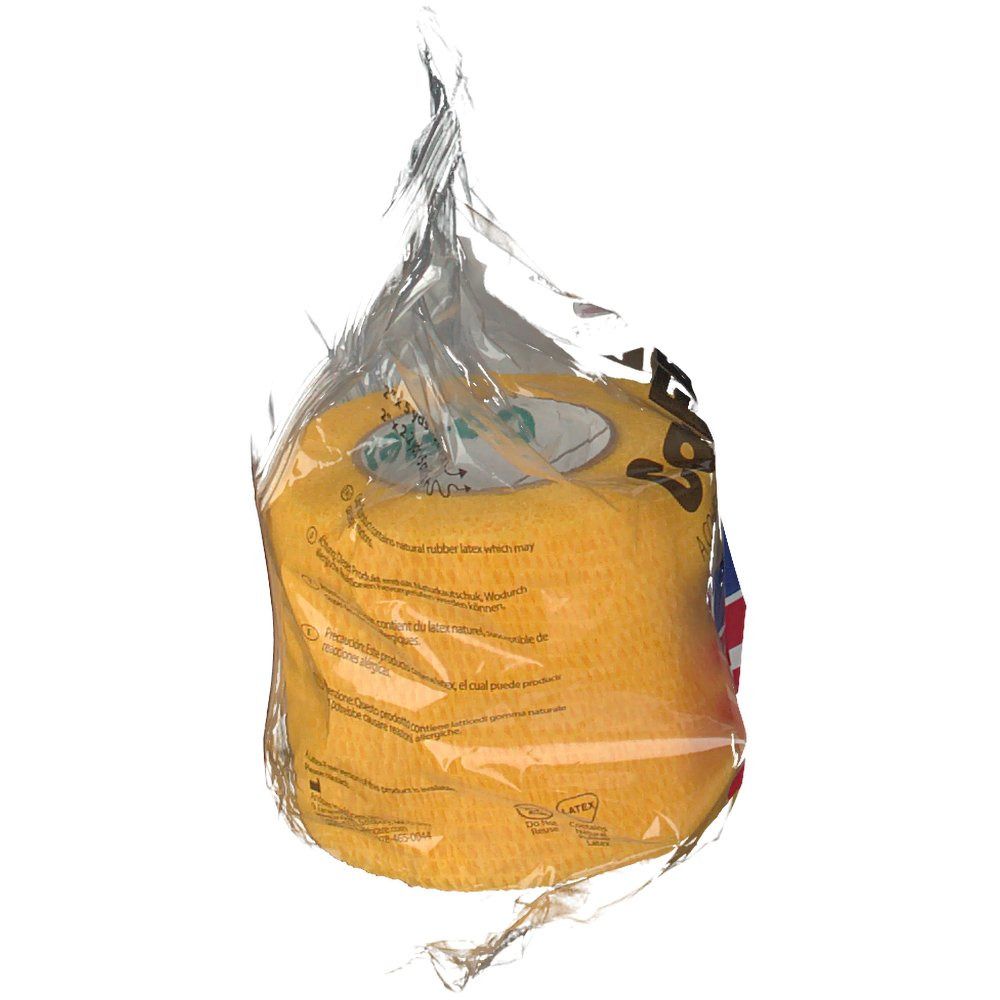 Gelbe Bandage in transparenter Verpackung. Aufdruck: CoFlex, amerikanische Flagge. Verpackung teilweise geöffnet.
