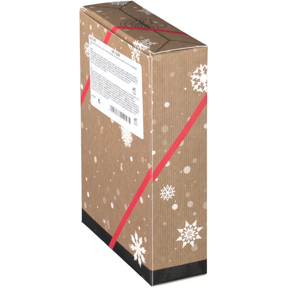 Seitenansicht der Geschenkset-Verpackung. Text auf weißem Etikett. Verpackung mit Schneeflocken-Design und roter Schleife.