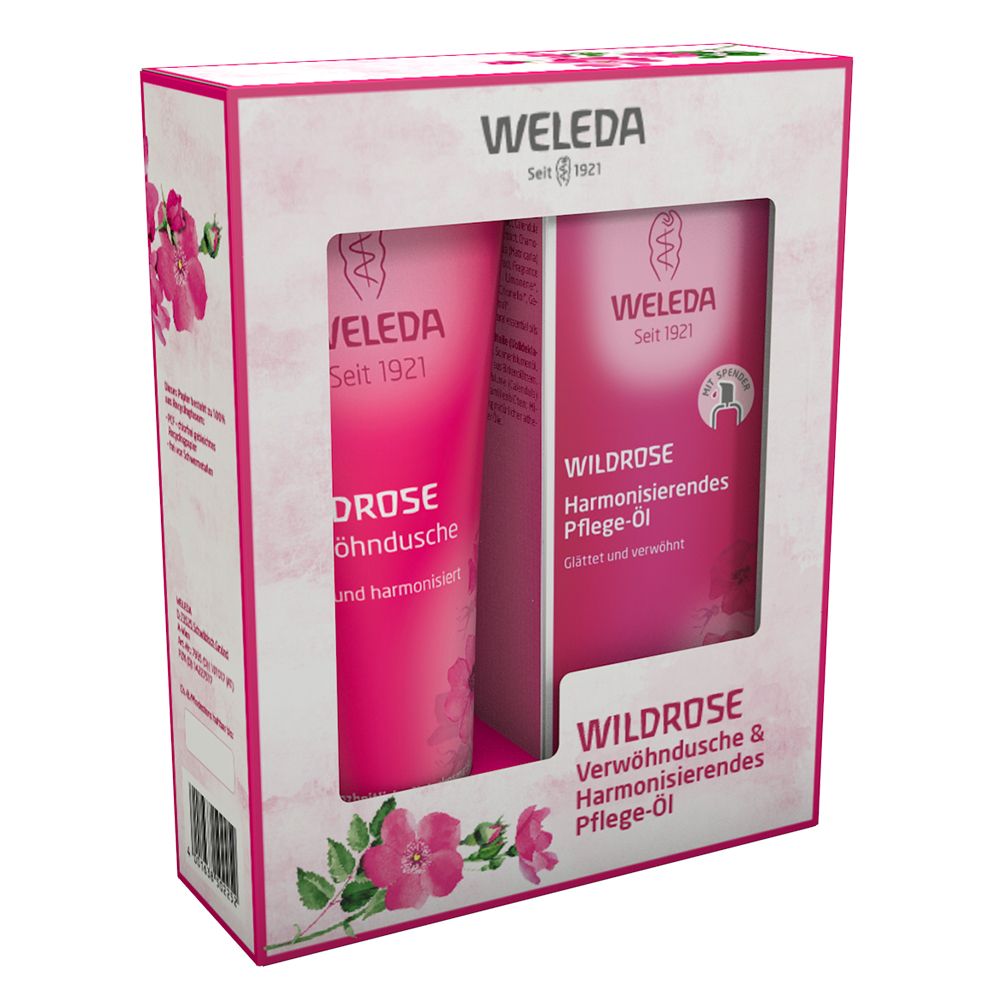 Geschenkbox mit Sichtfenster. Rosa Tube und Karton. Aufschrift: WELEDA, WILDROSE, Verwöhndusche & Harmonisierendes Pflege-Öl. Rosenblüten.