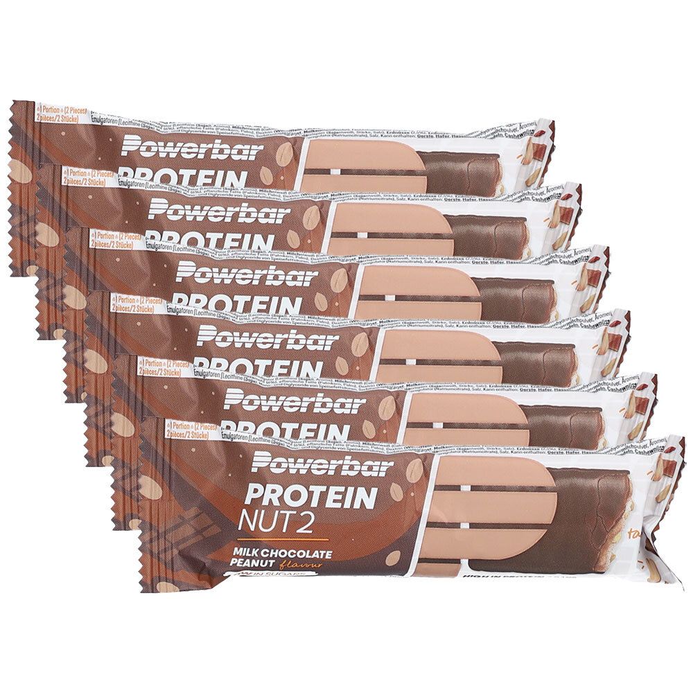 Sechs Proteinriegel in Verpackung. Aufdruck: Powerbar Protein Nut2 Milk Chocolate Peanut.