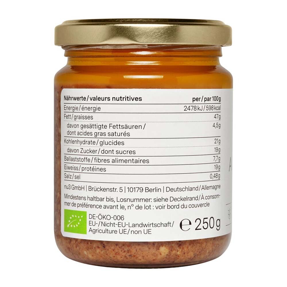 Rückseite des Glases mit nu3 Bio Gebrannte-Mandel-Aufstrich. Nährwerttabelle, DE-ÖKO-006 Siegel, Vegan-Siegel, 250g.