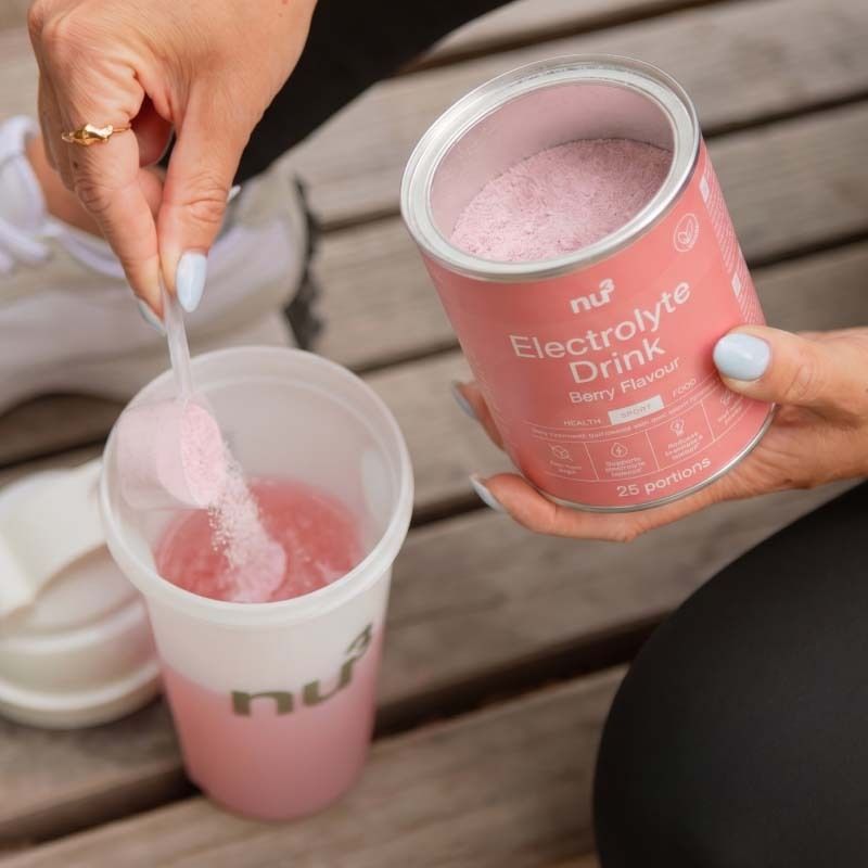 Zubereitung von nu3 Elektrolyte Drink Berry: Pulver wird in einen Becher gegeben.