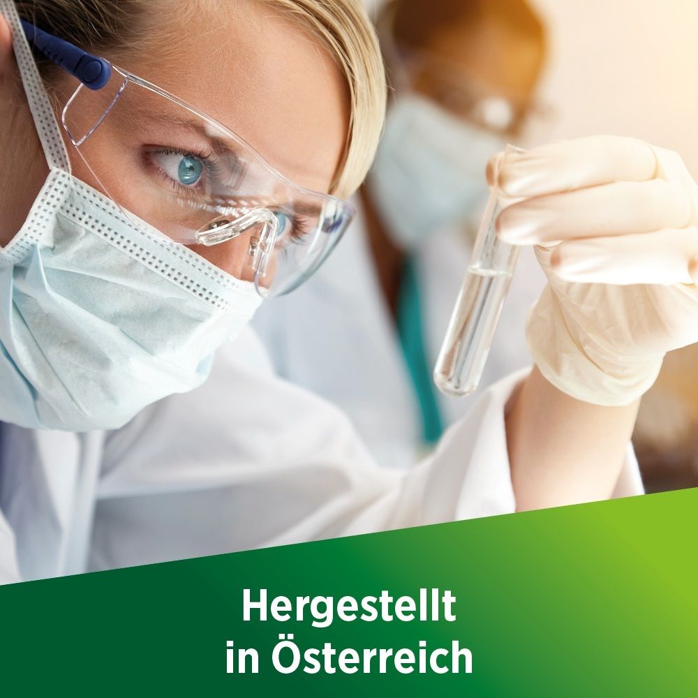 Wissenschaftlerin im Labor mit Reagenzglas. Text: Hergestellt in Österreich.