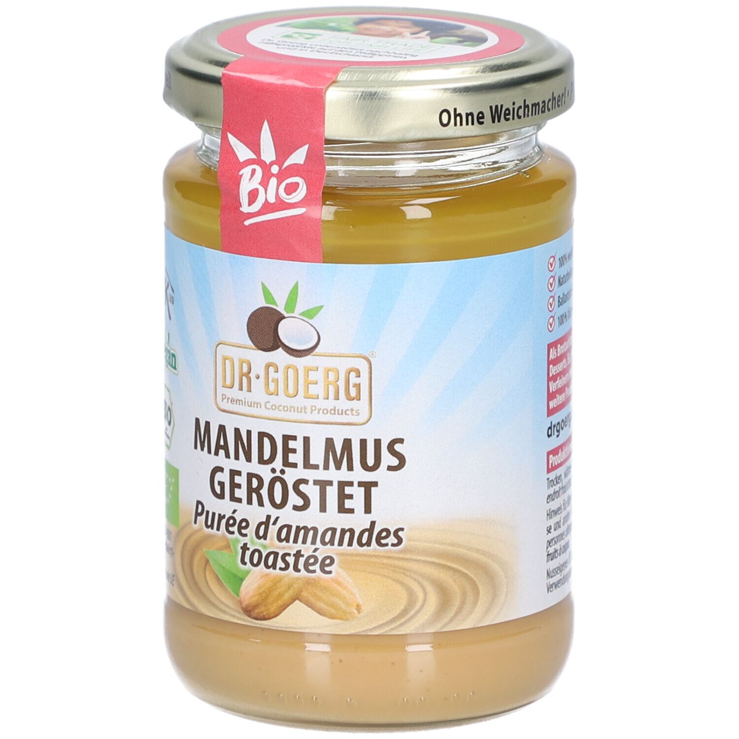 Glas mit Mandelmus, geröstet. Etikett mit Bio-Siegel, Vegan-Logo und Produktname. Deckel mit Aufschrift.