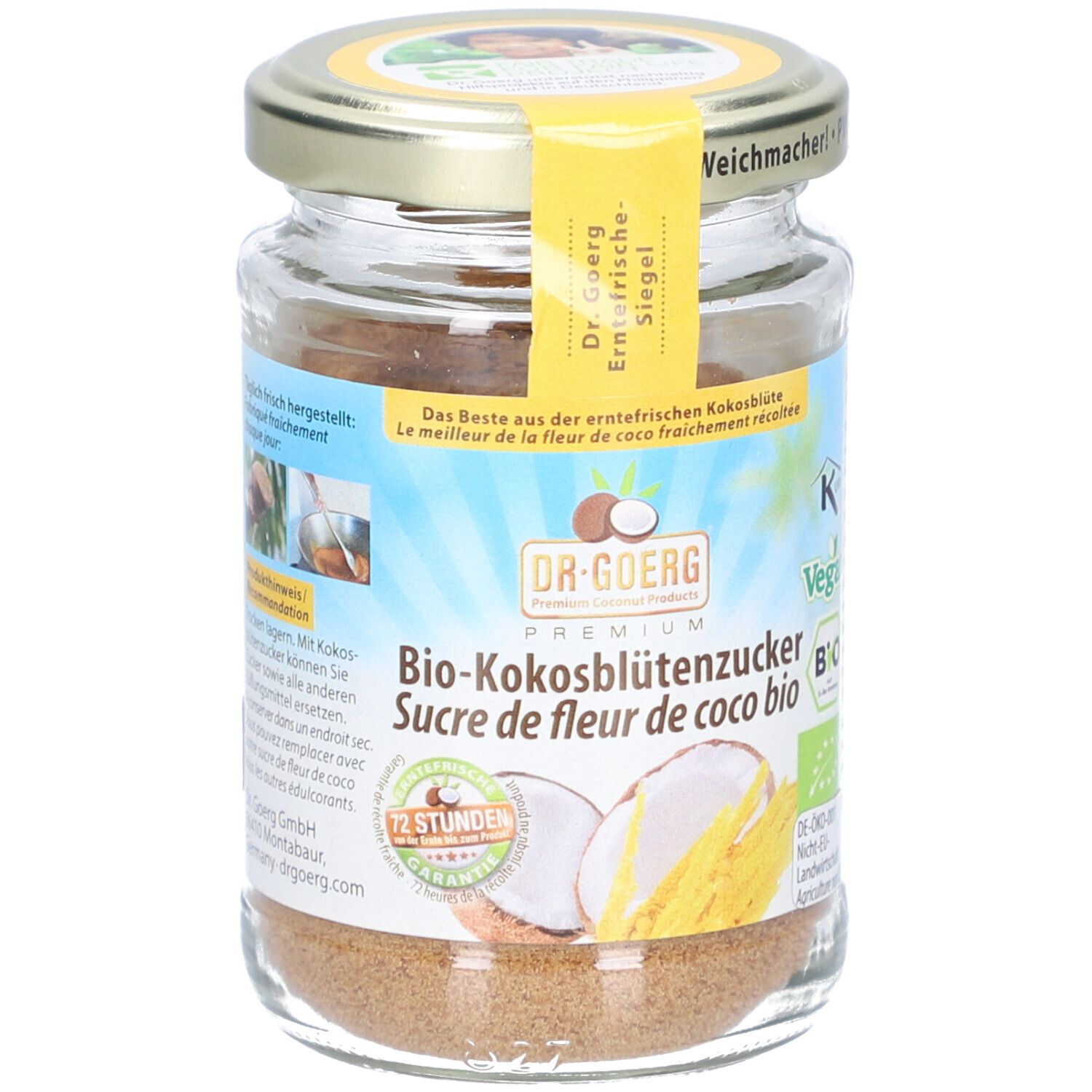 Glas mit Bio-Kokosblütenzucker. Gelbes Etikett mit Produktinformationen. Deckel mit Aufschrift.