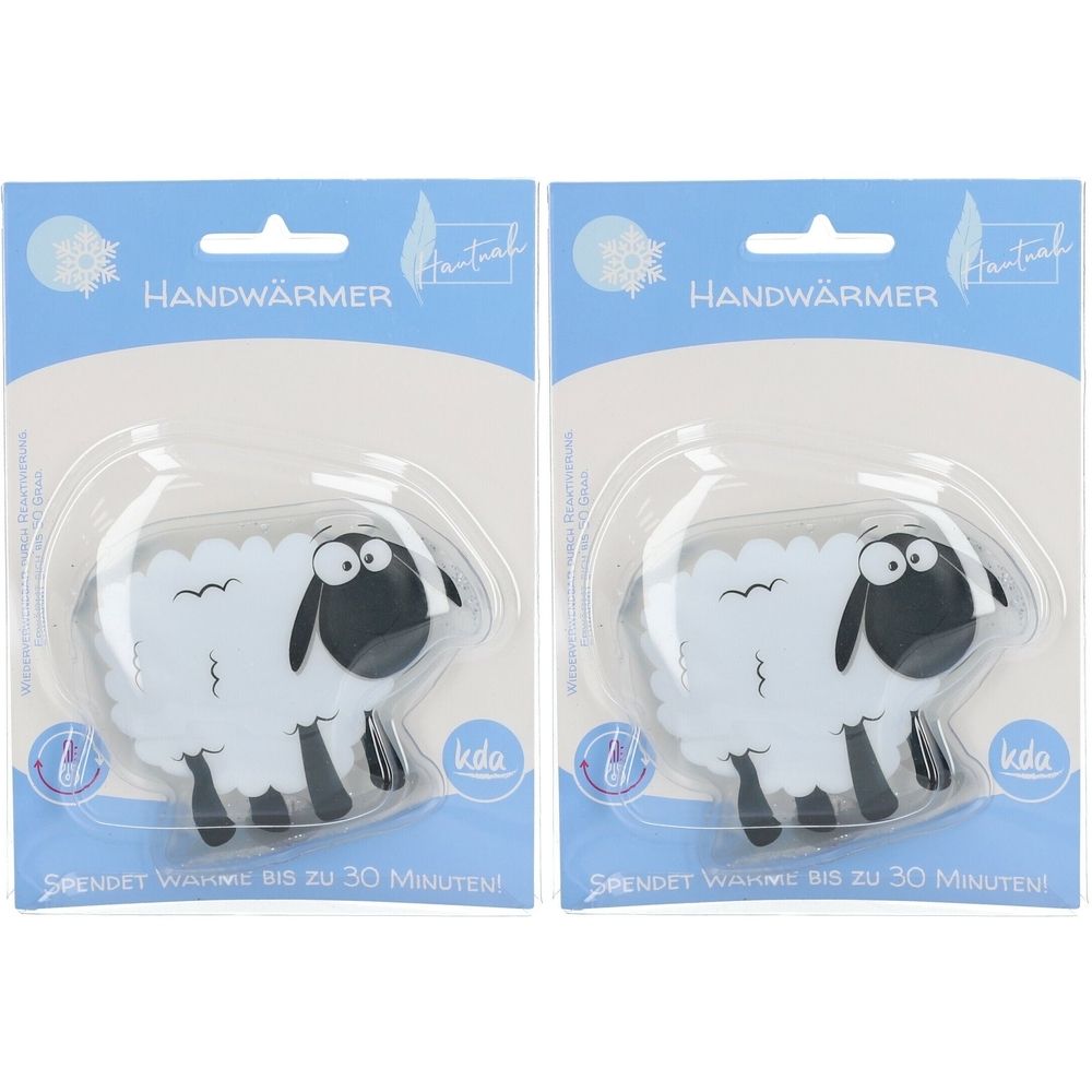 Zwei Handwärmer in Schaf-Form, verpackt. Weißes Schaf mit schwarzem Kopf und Beinen. Blaue Verpackung mit Schriftzug.