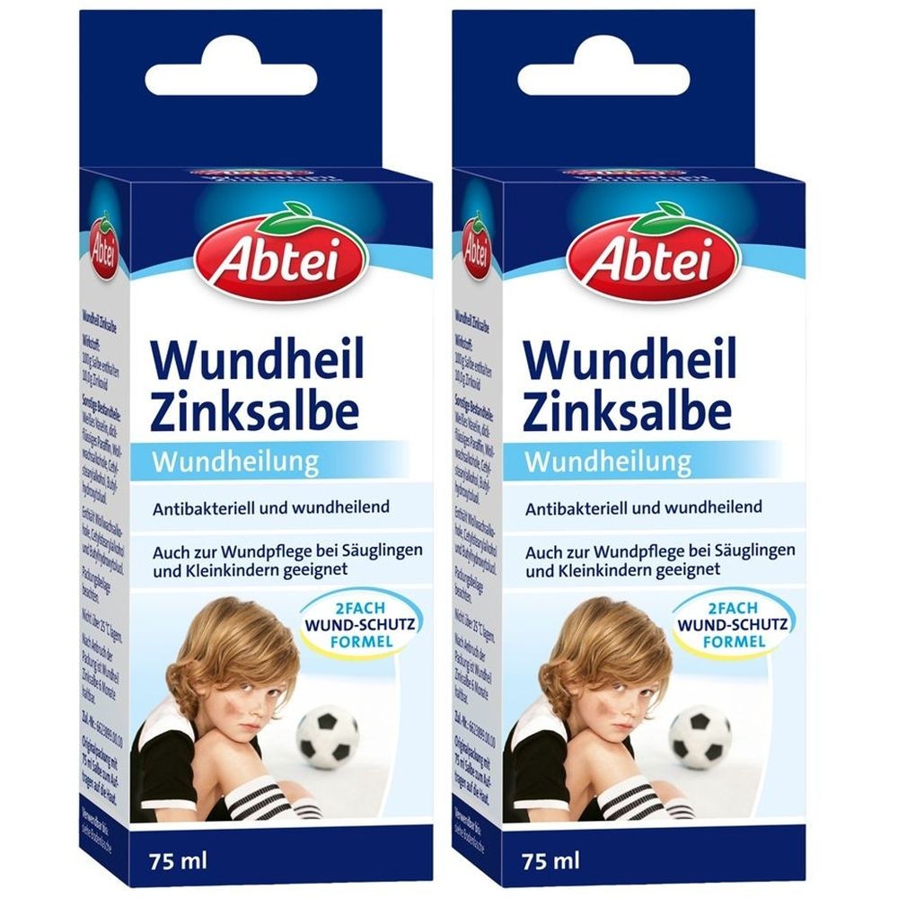 Zwei Schachteln Abtei Wundheil Zinksalbe. Blaue Verpackung mit Produktnamen, Logo und Kind mit Fußball. 75 ml.