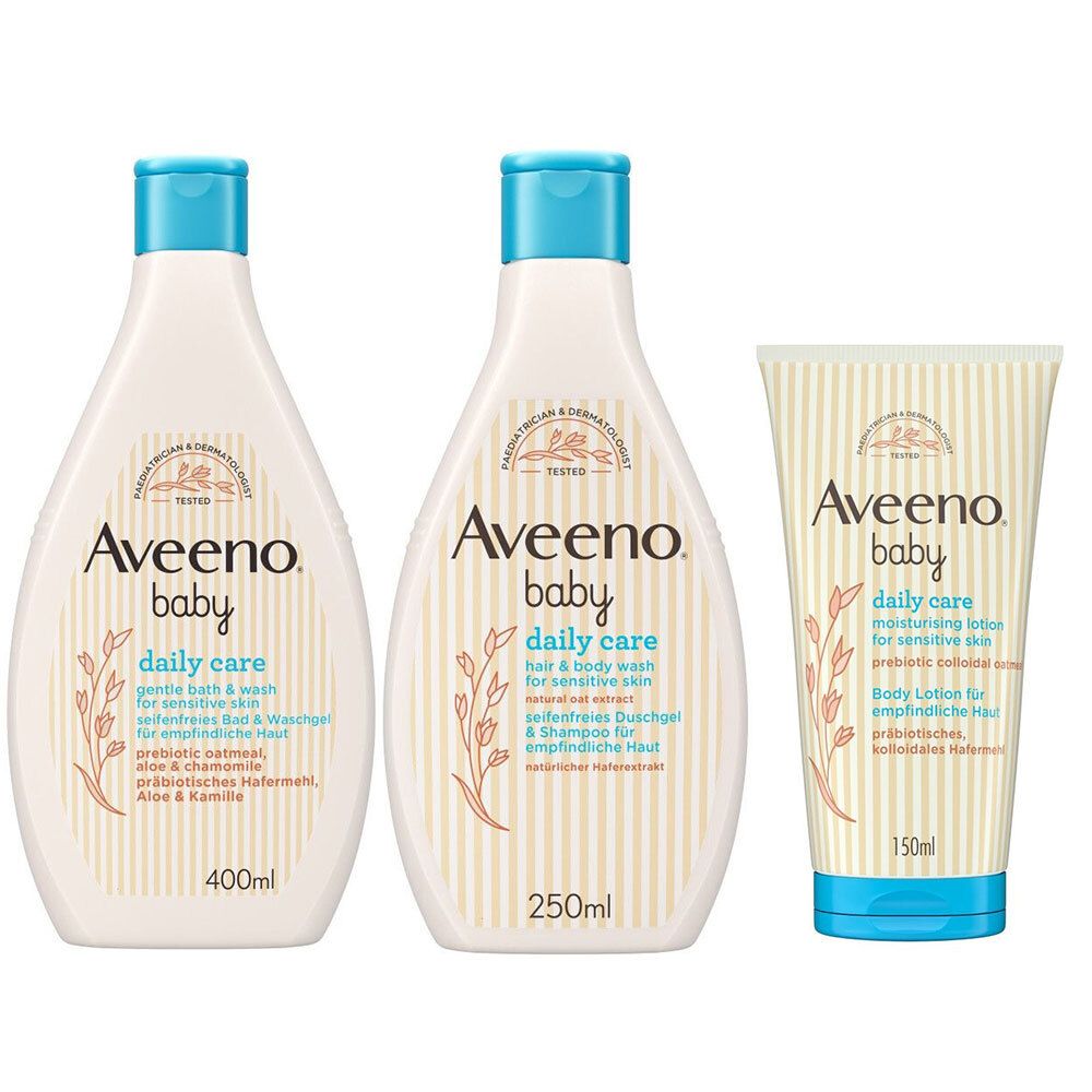 Drei Aveeno Baby Produkte: Bad & Waschgel, Shampoo & Duschgel, Lotion. Weiße Flaschen und Tube mit blauen Deckeln.