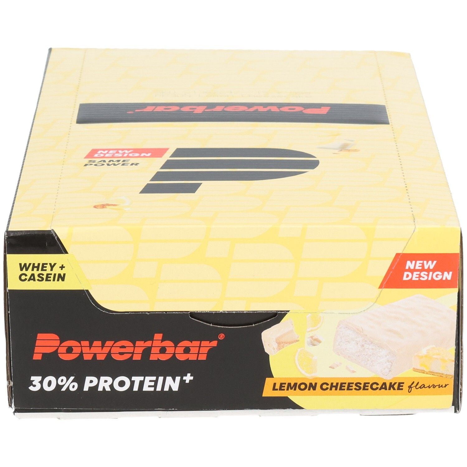 Gelbe Powerbar-Verpackung mit schwarzem Logo und Schriftzug. Enthält 30% Protein+. Aufdruck: Lemon Cheesecake. Neue Design-Kennzeichnung.