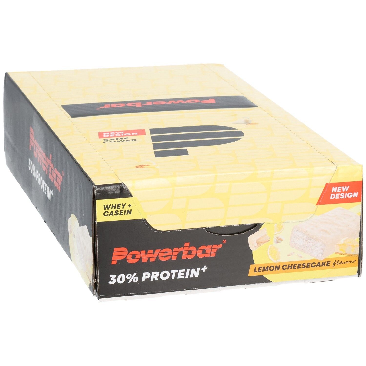 Gelbe Powerbar-Verpackung mit schwarzem Logo und Schriftzug. Enthält 30% Protein+. Aufdruck: Lemon Cheesecake. Neue Design-Kennzeichnung.