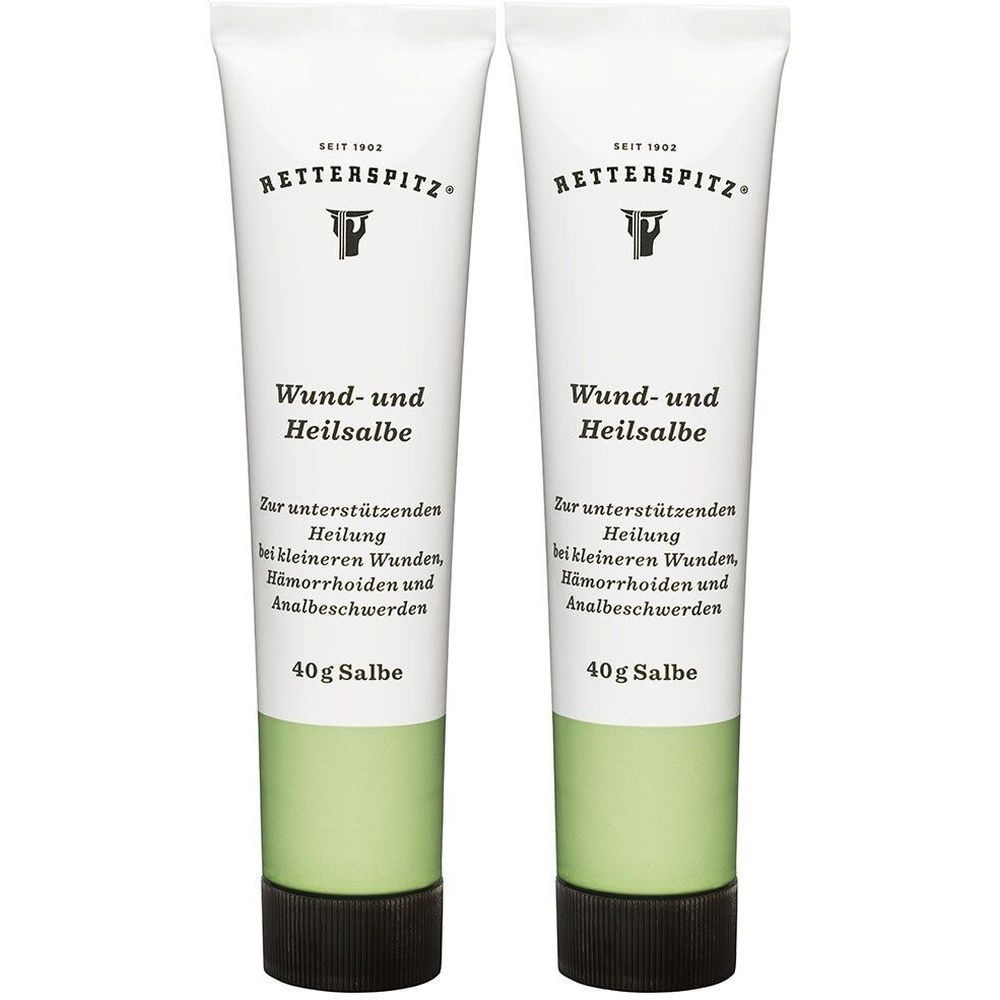 Zwei Tuben RETTERSPITZ Wund- und Heilsalbe. Weiße Tuben mit grünen und schwarzen Akzenten. Text: Wund- und Heilsalbe, 40g Salbe.