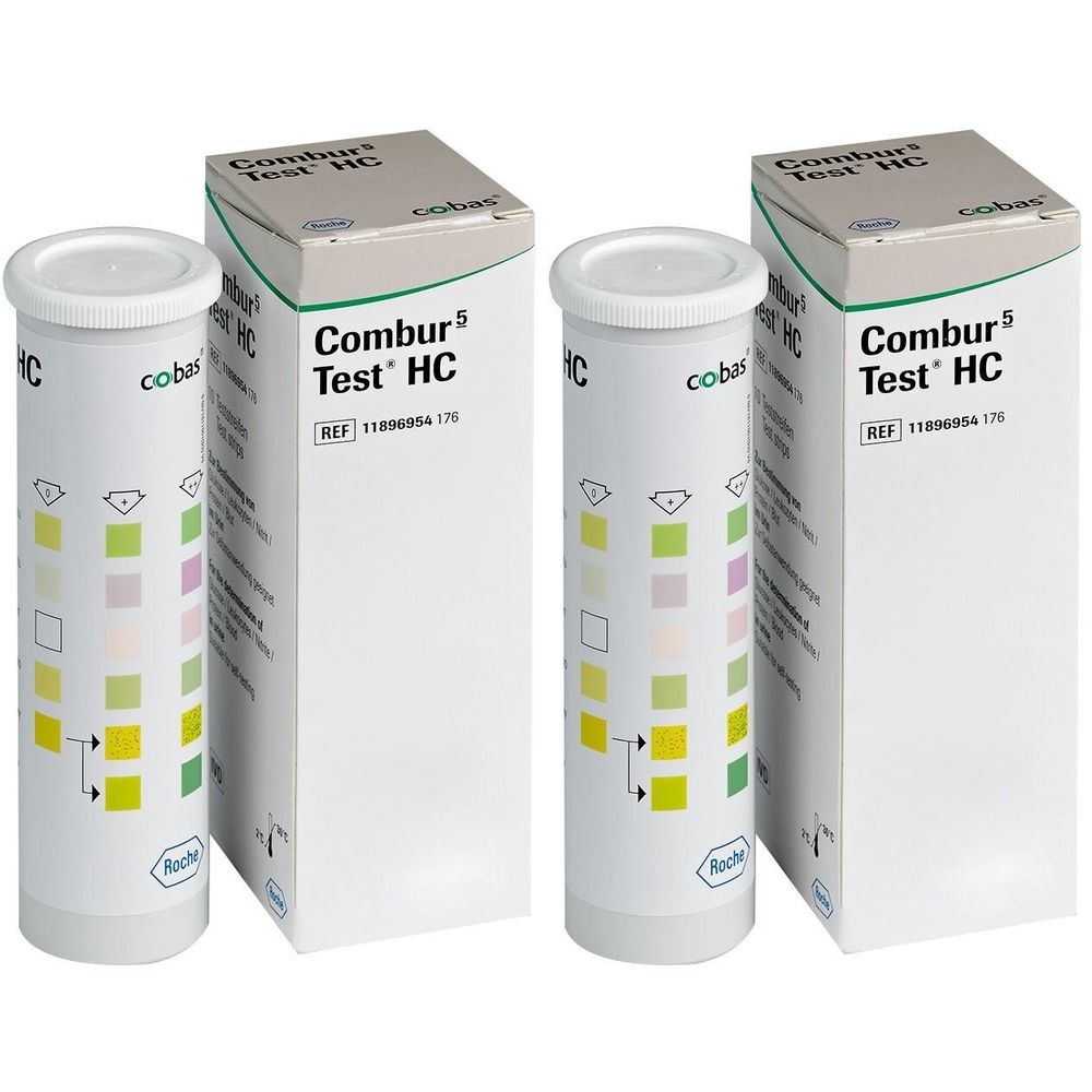 Zwei Packungen und zwei Teströhrchen. Aufschrift: Combur 5 Test HC. Röhrchen mit farbigen Testfeldern. Verpackung weiß mit grüner Schrift.