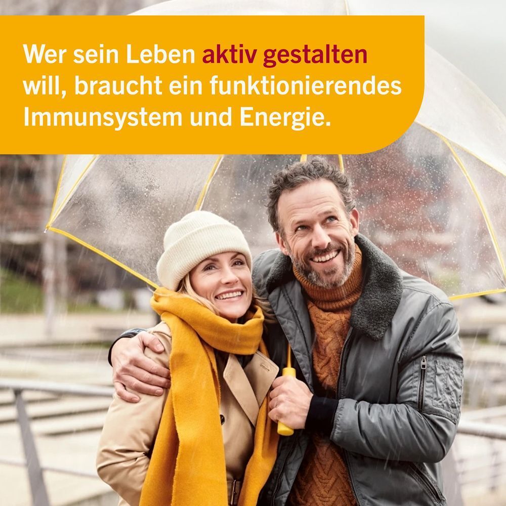 Paar unter einem Regenschirm, lächelnd. Text: Aktives Leben, Immunsystem, Energie.