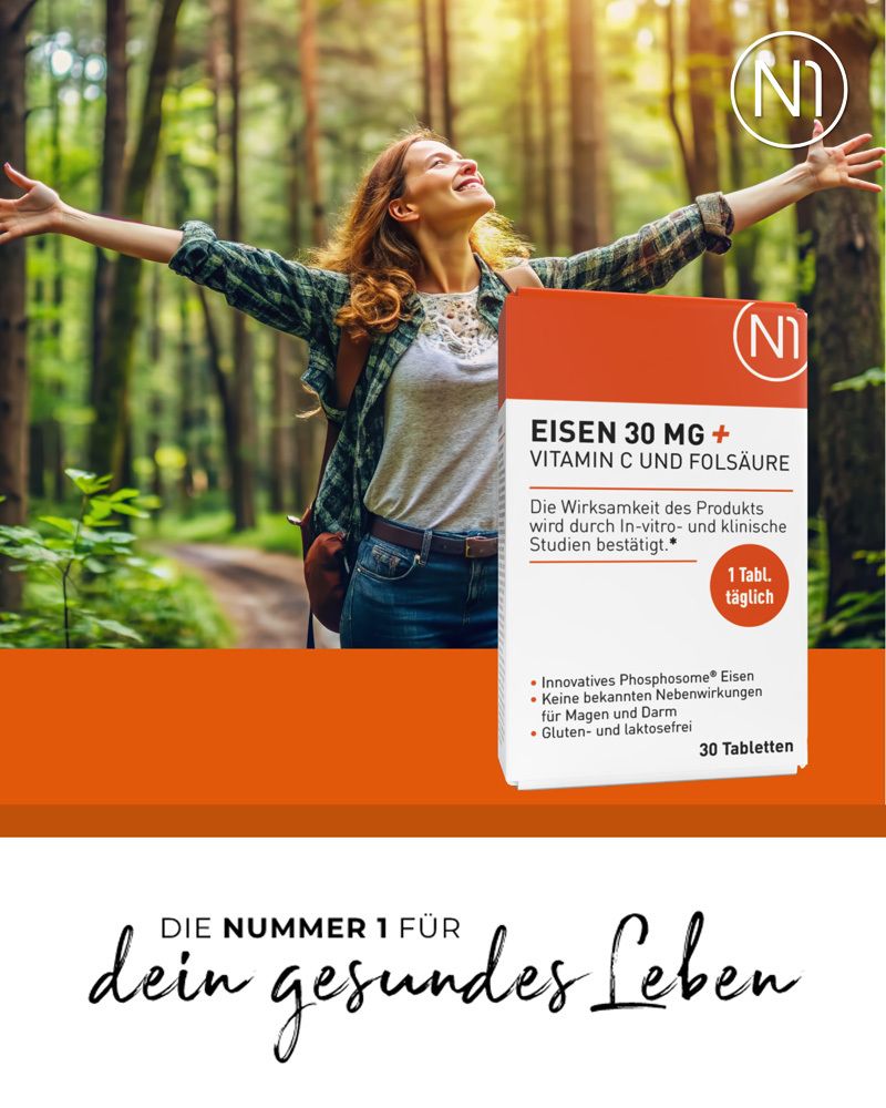 N1 Eisentabletten 30 mg mit Vitamin C und Folsäure in einer Frau in freier Natur. "Die Nummer 1 für dein gesundes Leben".